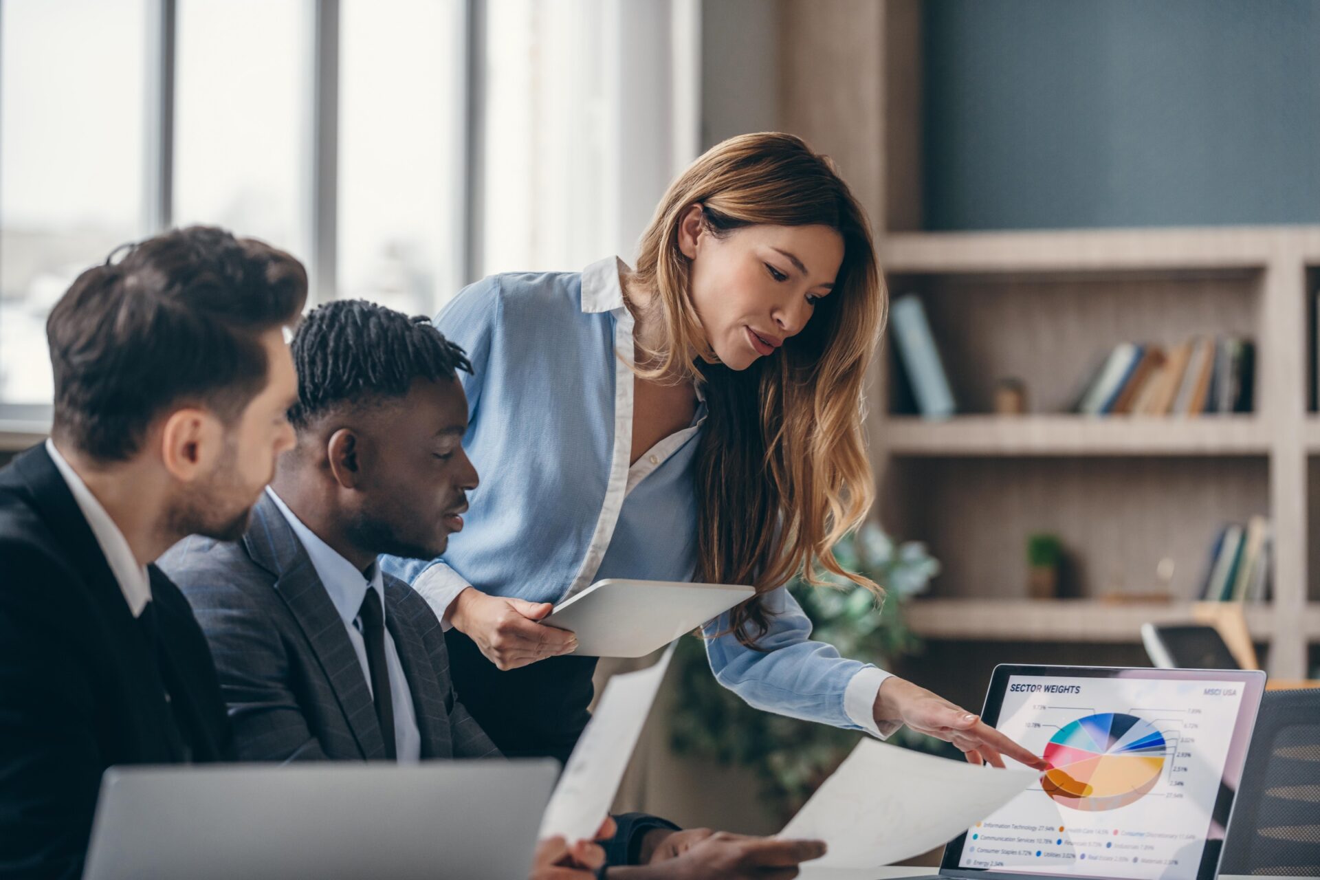 A diverse team of employees in a brainstorming session, illustrating a psychological safe space for raising cyber risk concerns and critical thinking in financial institutions.